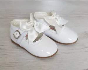 White patent bow shoes